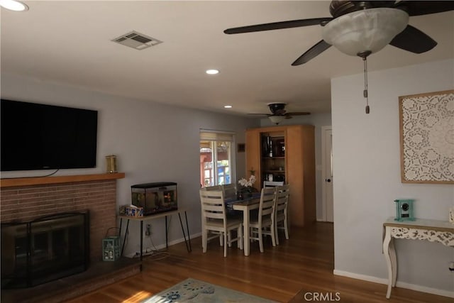 dining area with a fireplace and hardwood / wood-style floors