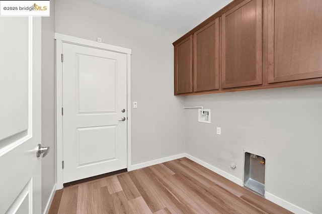 laundry area with cabinets, hookup for a gas dryer, electric dryer hookup, light hardwood / wood-style floors, and washer hookup