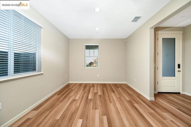 unfurnished room with light hardwood / wood-style flooring