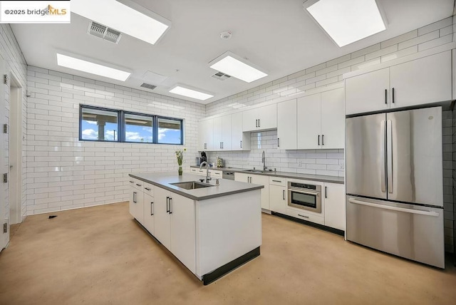 kitchen with sink, white cabinetry, and appliances with stainless steel finishes