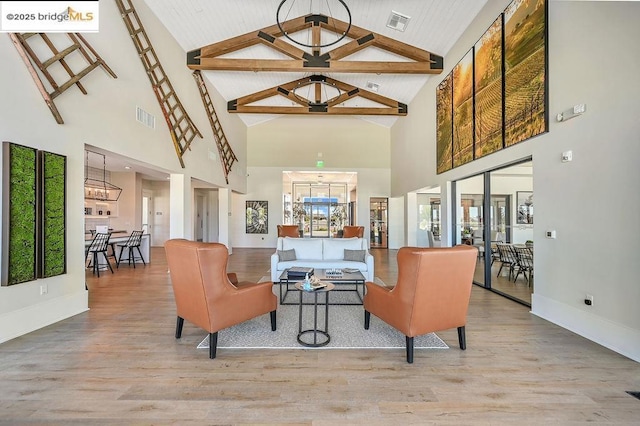 interior space featuring high vaulted ceiling, beamed ceiling, and light wood-type flooring