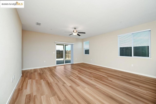 spare room featuring ceiling fan and light hardwood / wood-style floors