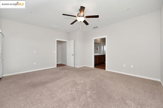 carpeted spare room with ceiling fan