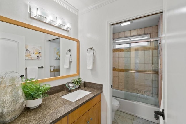 full bathroom featuring toilet, combined bath / shower with glass door, tile patterned flooring, crown molding, and vanity