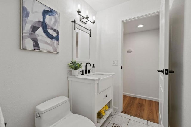 bathroom featuring toilet, tile patterned floors, and vanity