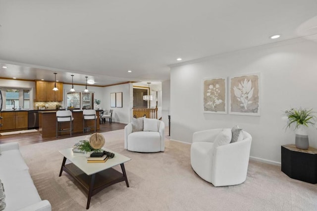 living room with crown molding and light colored carpet