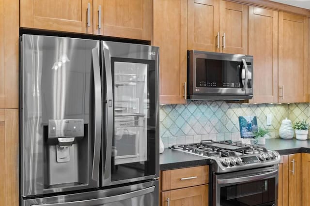 kitchen with appliances with stainless steel finishes and tasteful backsplash