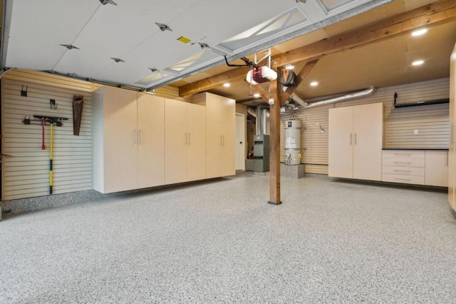 garage with secured water heater and a garage door opener