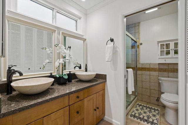 bathroom with toilet, a shower with shower door, tile patterned flooring, tile walls, and vanity