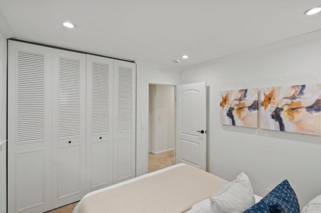 bedroom with a closet and crown molding