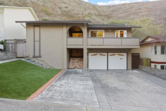 view of front of home featuring a mountain view, a balcony, and a garage