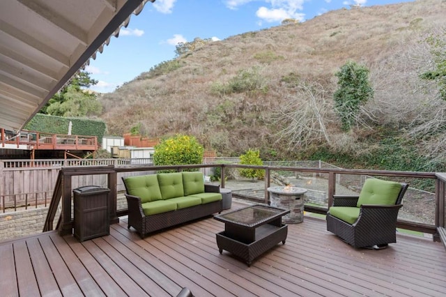 deck with a mountain view and outdoor lounge area