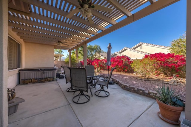 view of patio / terrace with ceiling fan, a pergola, and a hot tub