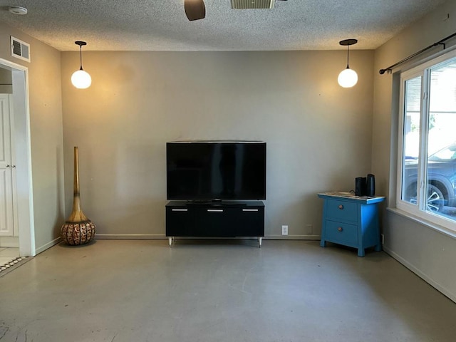 unfurnished living room with ceiling fan