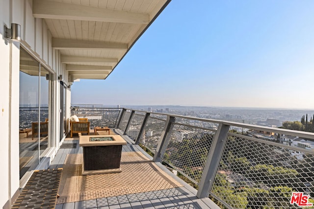 balcony featuring an outdoor fire pit