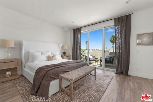 bedroom featuring access to outside and light hardwood / wood-style flooring