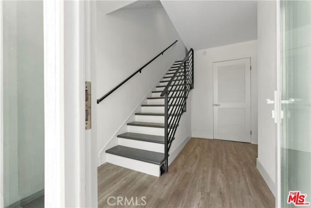 stairway with hardwood / wood-style flooring