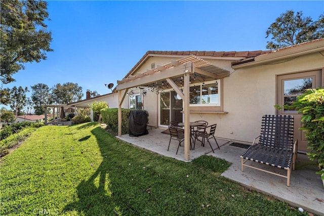 rear view of house with a patio area, a lawn, and a pergola