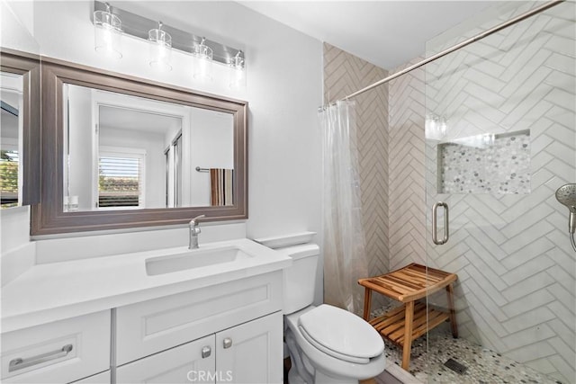 bathroom featuring curtained shower, toilet, and vanity