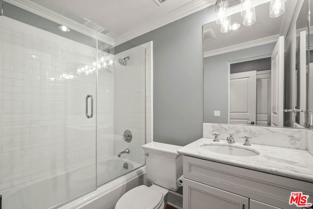 full bathroom with toilet, vanity, crown molding, and shower / bath combination with glass door