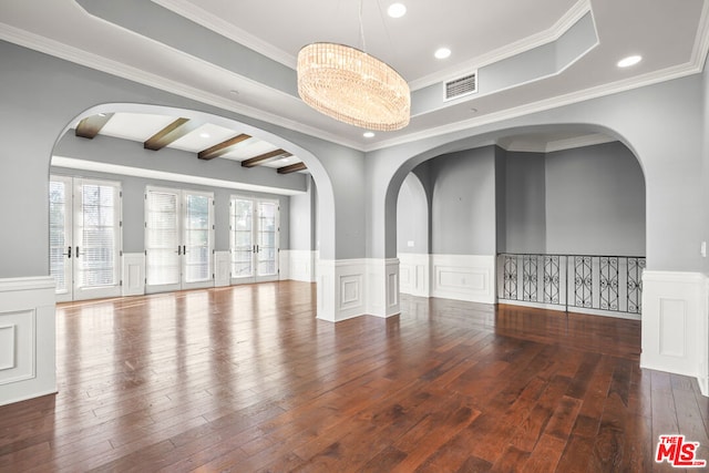 spare room featuring dark wood-type flooring, beamed ceiling, crown molding, and french doors