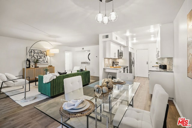 dining space with light wood-type flooring