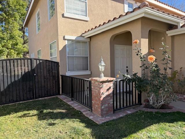 property entrance with a lawn