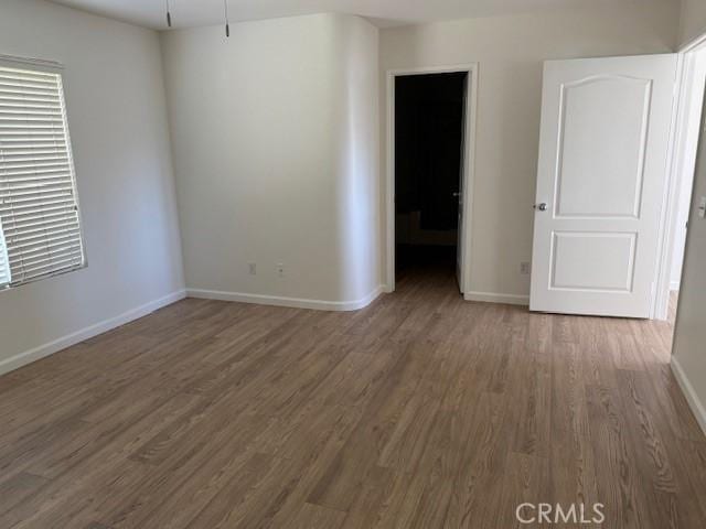 empty room featuring dark hardwood / wood-style flooring