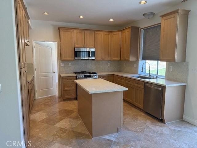 kitchen featuring appliances with stainless steel finishes, backsplash, a kitchen island, and sink