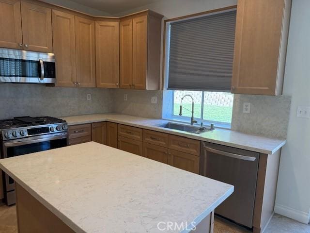 kitchen with tasteful backsplash, appliances with stainless steel finishes, and sink