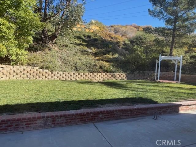 view of home's community with a patio and a yard