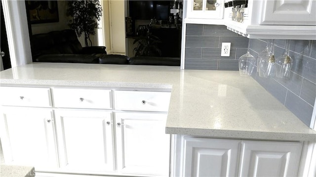 kitchen with white cabinetry and backsplash