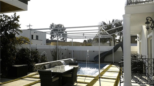 view of patio / terrace featuring a fenced in pool and a pergola