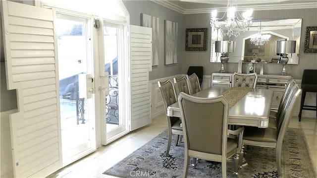 dining area with light tile patterned floors, crown molding, and a chandelier