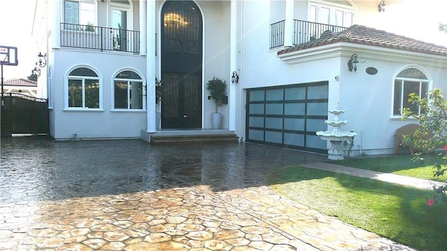 view of exterior entry featuring a balcony