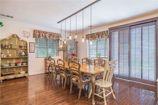 dining space featuring dark hardwood / wood-style floors