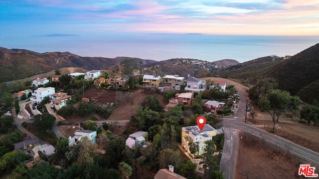 aerial view at dusk featuring a mountain view