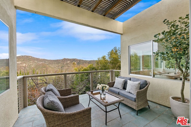 balcony with a mountain view and an outdoor living space