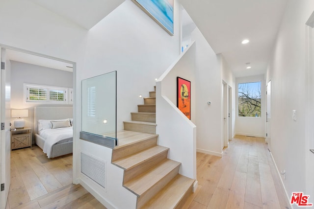 staircase with hardwood / wood-style flooring