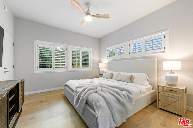 bedroom with ceiling fan and light wood-type flooring