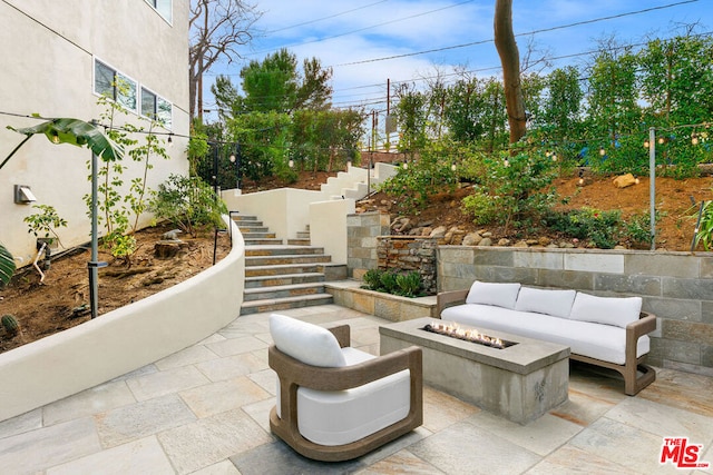 view of patio / terrace featuring an outdoor living space with a fire pit