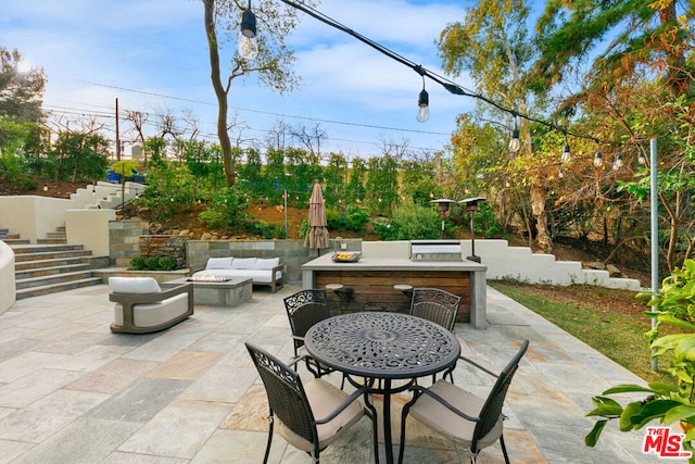 view of patio featuring an outdoor living space with a fire pit and an outdoor bar