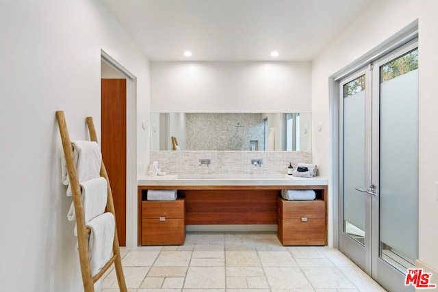 bathroom with vanity and decorative backsplash