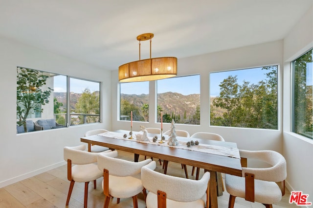 sunroom featuring a mountain view