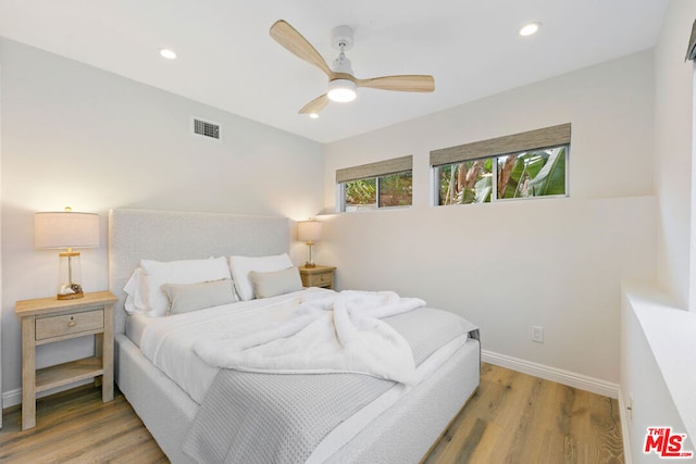 bedroom with ceiling fan and hardwood / wood-style floors