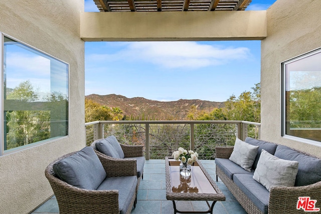 balcony featuring a mountain view and outdoor lounge area