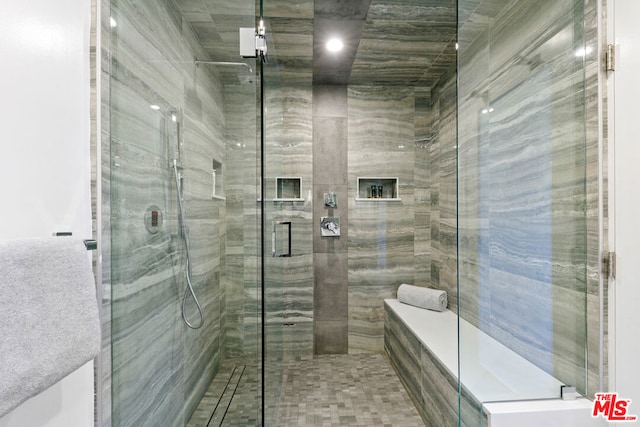 bathroom with a shower with door