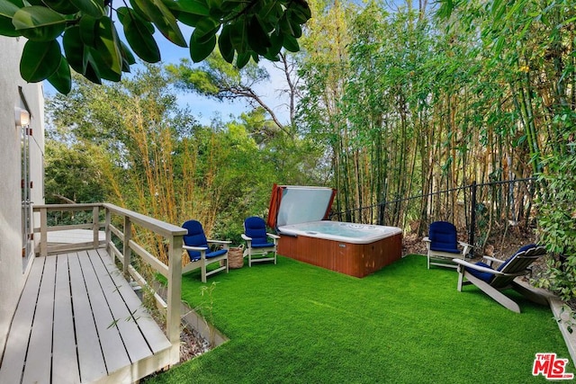 view of yard with a hot tub and a wooden deck