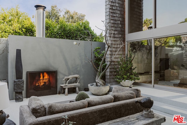 view of patio featuring an outdoor fireplace