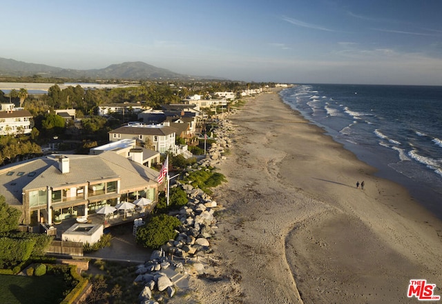 birds eye view of property with a view of the beach and a water view